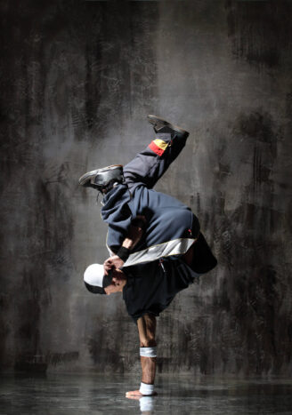 modern style dancer posing on dirty grunge background